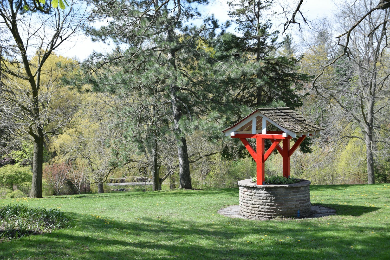 a sign in front of some trees and bushes